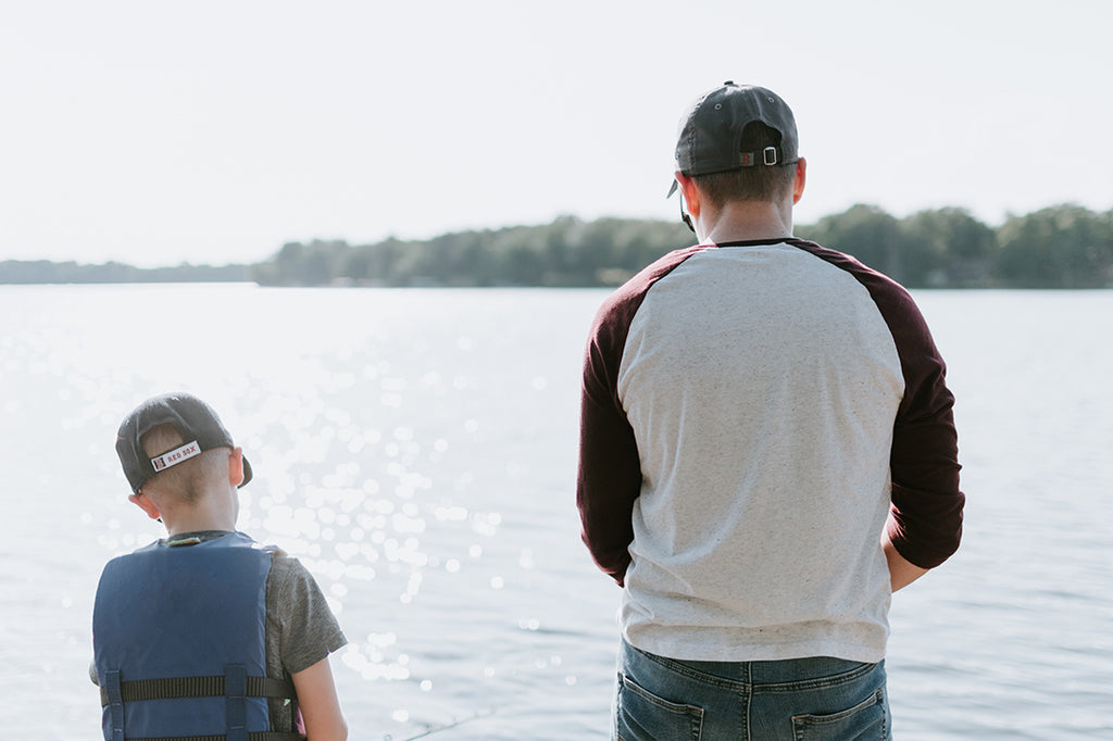 Father and son beside a lake